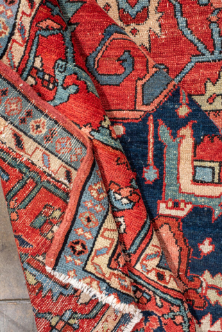 Antique Persian Serapi Carpet, circa 1900. Featuring a bold geometric medallion on a richly saturated red field, accented by deep navy, ivory, and soft sky-blue tones. The spacious composition is filled with  ...
