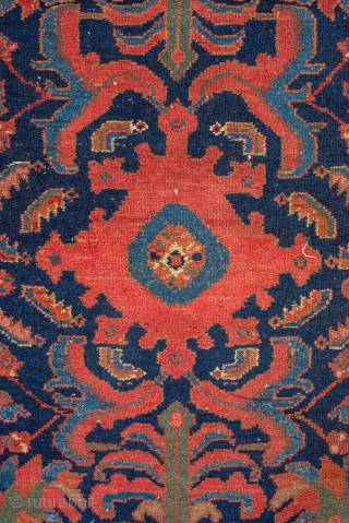 Antique Persian Malayer Rug, circa 1920. Featuring a bold, stylized medallion and angular floral motifs on a deep navy field with warm rust and soft blue accents, framed by a classic Heriz-inspired  ...
