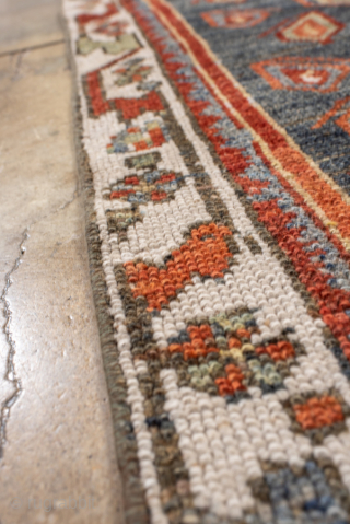 Antique Kurdish Rug, circa 1920. Featuring bold geometric medallions on a softly abrash blue-gray field with warm rust, ivory, and soft green accents, surrounded by a lively tribal border.

Item No. 101578

4'4" x  ...