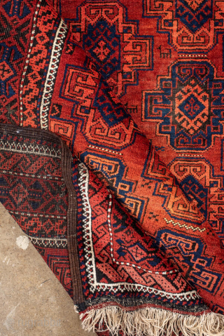 Antique Belouch Rug, circa 1920. Featuring repeating geometric guls on a rich red field with deep navy accents, framed by multiple narrow tribal borders. Compact, finely drawn design with classic Baluch character.

Item  ...