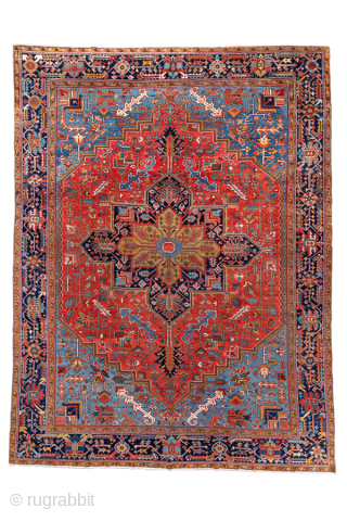 Antique Persian Heriz Rug, Circa 1910. Features a bold geometric medallion design rendered in vibrant shades of red, navy, sky blue, and camel. Commanding scale, rich colors, and durable construction make ...