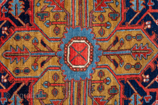 Antique Persian Heriz Rug, Circa 1910. Features a bold geometric medallion design rendered in vibrant shades of red, navy, sky blue, and camel. Commanding scale, rich colors, and durable construction make ...