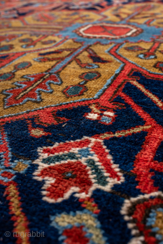 Antique Persian Heriz Rug, Circa 1910. Features a bold geometric medallion design rendered in vibrant shades of red, navy, sky blue, and camel. Commanding scale, rich colors, and durable construction make ...