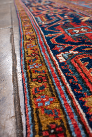 Antique Persian Heriz Rug, Circa 1910. Features a bold geometric medallion design rendered in vibrant shades of red, navy, sky blue, and camel. Commanding scale, rich colors, and durable construction make ...