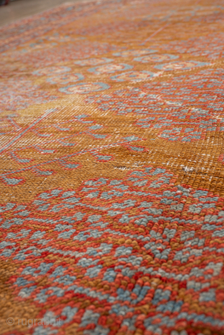 Antique Persian Bakhshayesh Carpet, Circa 1900. Features a softly aged camel field adorned with delicate repeating geometric floral motifs, framed by an elegant pale blue border.

9'0" x 12'2"

Item No: 101851   