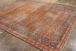 Antique Persian Bakhshayesh Carpet, Circa 1900. Features a softly aged camel field adorned with delicate repeating geometric floral motifs, framed by an elegant pale blue border.

9'0" x 12'2"

Item No: 101851   