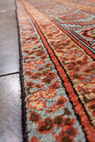 Antique Persian Bakhshayesh Carpet, Circa 1900. Features a softly aged camel field adorned with delicate repeating geometric floral motifs, framed by an elegant pale blue border.

9'0" x 12'2"

Item No: 101851   