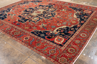 Antique Persian Serapi Carpet, Circa 1900. Striking ivory cruciform medallion on a vibrant terracotta-red field framed by deep midnight-blue corner spandrels and an elegant floral border.

9'4" x 12'4"

Item No: 101990   