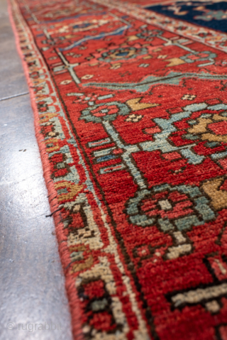 Antique Persian Serapi Carpet, Circa 1900. Striking ivory cruciform medallion on a vibrant terracotta-red field framed by deep midnight-blue corner spandrels and an elegant floral border.

9'4" x 12'4"

Item No: 101990   