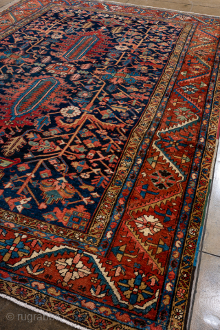 Antique Persian Serapi Carpet, Circa 1900. Features a deep midnight-blue field filled with stylized botanical motifs and twin elongated geometric medallions framed by a vibrant rust-red border.

8'6" x 12'9"

Item No: 95428  