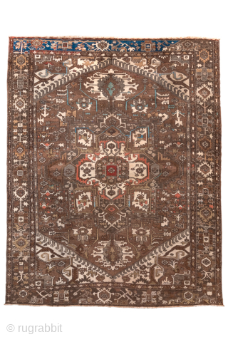 Antique Persian Serapi Carpet, Circa 1900. Features a rare walnut-brown field with a striking geometric medallion highlighted by ivory, muted blue, and terracotta accents.

9'9" x 12'4"

Item No: 98529     