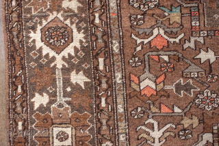 Antique Persian Serapi Carpet, Circa 1900. Features a rare walnut-brown field with a striking geometric medallion highlighted by ivory, muted blue, and terracotta accents.

9'9" x 12'4"

Item No: 98529     