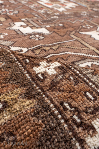 Antique Persian Serapi Carpet, Circa 1900. Features a rare walnut-brown field with a striking geometric medallion highlighted by ivory, muted blue, and terracotta accents.

9'9" x 12'4"

Item No: 98529     