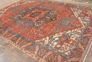 Antique Persian Serapi Carpet, Circa 1900. Striking stepped brick-red medallion surrounded by ivory and deep blue geometric motifs in the bold tribal style of the Heriz region.

9'1" x 12'5"

Item No: 99718  