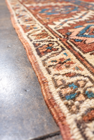 Antique Persian Serapi Carpet, Circa 1900. Striking stepped brick-red medallion surrounded by ivory and deep blue geometric motifs in the bold tribal style of the Heriz region.

9'1" x 12'5"

Item No: 99718  