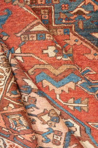 Antique Persian Serapi Carpet, Circa 1900. Striking stepped brick-red medallion surrounded by ivory and deep blue geometric motifs in the bold tribal style of the Heriz region.

9'1" x 12'5"

Item No: 99718  