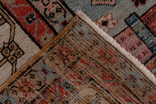 Antique Persian Serapi Carpet, Circa 1900. Rare, spacious design with a large terracotta lozenge medallion set against an ivory field accented by soft sky-blue spandrels.
11'5" x 16'8"
Item No: 59200