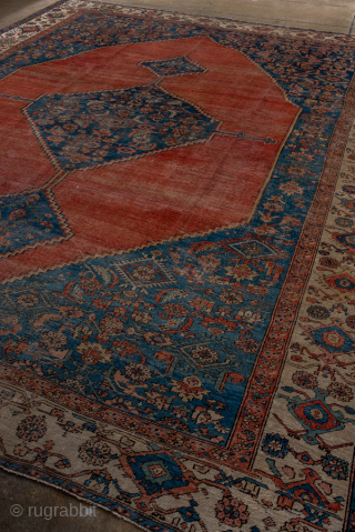 Antique Persian Serapi Carpet, Circa 1900. Dramatic oversized salmon-red medallion set against a richly detailed indigo field and framed by an elegant ivory border.
11'1" x 13'9"
Item No: 95849