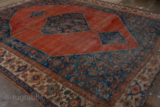 Antique Persian Serapi Carpet, Circa 1900. Dramatic oversized salmon-red medallion set against a richly detailed indigo field and framed by an elegant ivory border.
11'1" x 13'9"
Item No: 95849