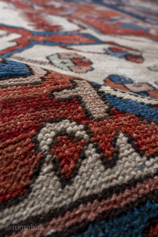 Antique Persian Serapi Carpet, Circa 1900. Dramatic stepped medallion set within a richly abrashed terracotta and indigo field framed by bold ivory spandrels and a geometric border.
11'2" x 15'9"
Item No: 97824