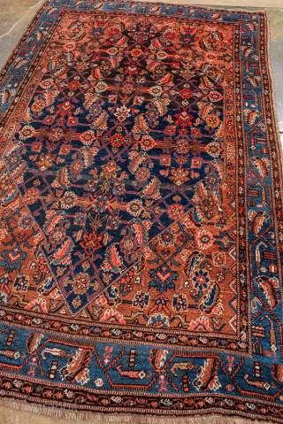 Antique Persian Bidjar Rug, Circa 1920. Elegant allover Herati design woven across a deep navy field, framed by warm camel spandrels and a vibrant sky-blue turtle border.
4'6" x 7'9"
Item No: 101378