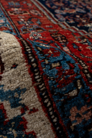Antique Persian Bidjar Carpet, Circa 1920. Richly detailed midnight blue Herati medallion set within a terracotta field and framed by an elegant ivory turtle-palmette border.
4'10" x 7'7"
Item No: 95952