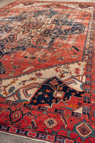 Antique Persian Serapi Carpet, Circa 1900. Features a commanding cruciform medallion set within a richly abrashed terracotta field framed by ivory spandrels and a bold geometric border.
12'8" x 18'10"
Item No: 99818