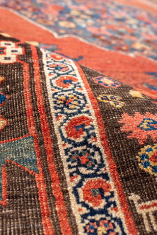 Antique Persian Bidjar Rug, Circa 1900. Bold indigo diamond medallion set against a warm salmon-red field adorned with stylized floral and geometric motifs.
4'8" x 9'7"
Item No: 99453