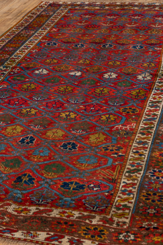 Antique Persian Kurdish Rug, Circa 1900. Finely woven allover lattice of hooked diamond medallions across a vibrant madder-red field framed by elegant ivory and geometric tribal borders.
4'8" x 8'8"
Item No: 41320