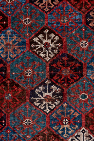 Antique Persian Kurdish Rug, Circa 1900. Finely detailed allover lattice of octagonal tribal motifs woven across a rich midnight blue field framed by crisp ivory geometric borders.
4'0" x 8'7"
Item No: C68492