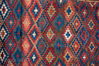 Antique Persian Kurdish Rug, Circa 1900. Vibrant allover lattice of hooked diamond motifs woven across a luminous sky-blue field framed by bold madder-red tribal borders.
4'3" x 8'4"
Item No: 85595