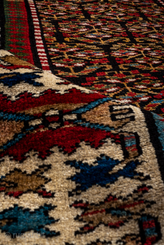Antique Persian Kurdish Runner, Circa 1900. Finely drawn allover floral design on a deep brown-black field framed by a distinctive ivory geometric border.
3'6" x 13'2"
Item No: 95605