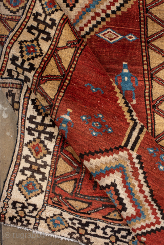 Antique Persian Kurdish Rug, Circa 1900. Striking stepped diamond medallions woven across a warm madder-red field accented by charming tribal figures and symbolic geometric motifs.
4'0" x 8'8"
Item No: 99969
