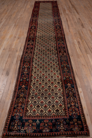 Antique Persian Kurdish Runner with Diamond Lattice Design, Circa 1900. Features a finely patterned diamond lattice across a muted field framed by deep indigo and madder-red borders.
3'1" x 16'10"
Item No: 56644