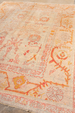 Item 99687 
8'10 x 10'9 

This charming antique Oushak rug features a soft, time-worn palette of blush, apricot, and golden tones that feel warm and inviting. Its open field is decorated with  ...