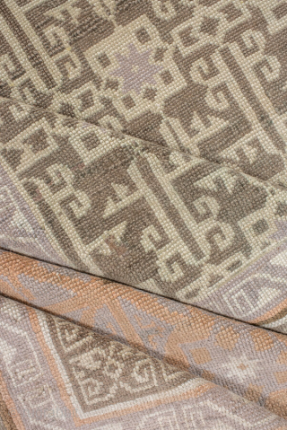 This elegant antique Oushak rug showcases a beautifully detailed allover lattice design in soft sage green and ivory, framed by a wide border in warm peach and golden tones. Its geometric patterning  ...