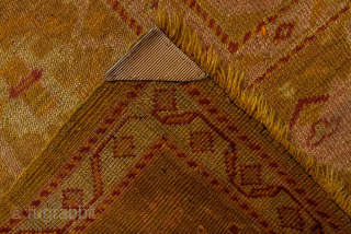 This antique Oushak rug glows with rich, warm tones of golden saffron, soft apricot, and muted blush. Its geometric medallion-and-corner design is framed by a beautifully drawn border, giving the rug a  ...