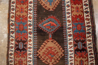 Antique Caucasian Kazak Runner with Geometric Medallions, Circa 1910. A succession of colorful geometric medallions across a dark field, surrounded by bold tribal borders.
3'6" x 13'6"
Item No: 102236