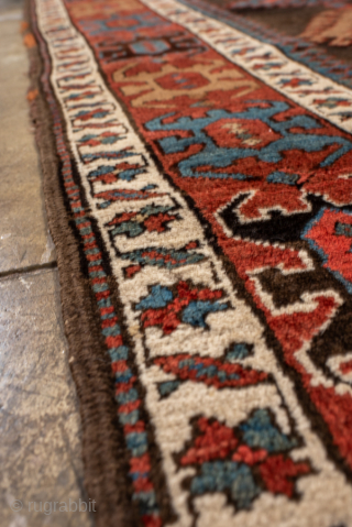 Antique Caucasian Kazak Runner with Geometric Medallions, Circa 1910. A succession of colorful geometric medallions across a dark field, surrounded by bold tribal borders.
3'6" x 13'6"
Item No: 102236