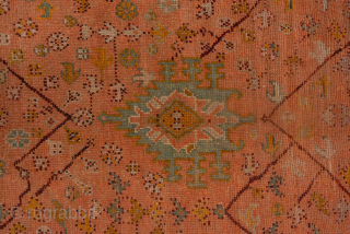 This antique Turkish Oushak rug, woven circa 1900, showcases a beautifully understated lattice and medallion design on a rich rust field framed by a wide gold border with delicate floral detailing. The  ...