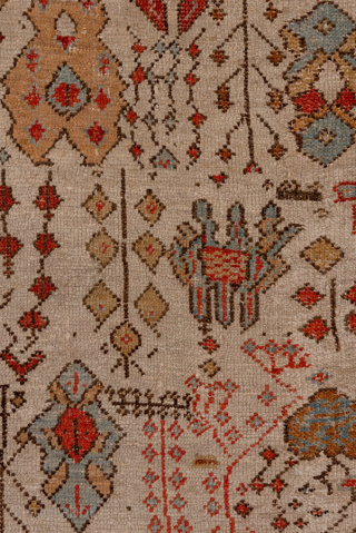 This antique Oushak rug, woven circa 1900, features a captivating Tree of Life design with stylized floral and botanical motifs cascading across an ivory field. The delicate, painterly pattern is framed by  ...