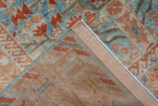 This antique Sivas rug, woven circa 1920, showcases a striking botanical garden design with stylized floral motifs and tree forms arranged in a symmetrical lattice pattern. The soft blue field is accented  ...