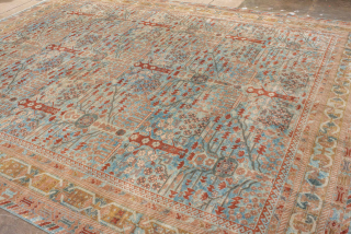 This antique Sivas rug, woven circa 1920, showcases a striking botanical garden design with stylized floral motifs and tree forms arranged in a symmetrical lattice pattern. The soft blue field is accented  ...