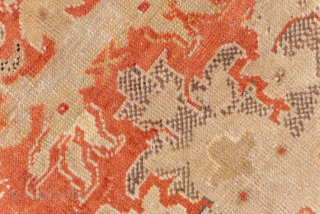 This antique Sivas rug from early 20th-century Turkey exudes timeless elegance with its intricate all-over floral design. Woven in a striking palette of warm coral, ivory, and soft beige, the rug balances  ...