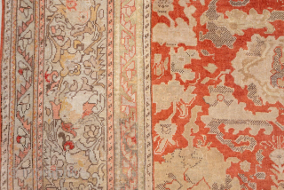 This antique Sivas rug from early 20th-century Turkey exudes timeless elegance with its intricate all-over floral design. Woven in a striking palette of warm coral, ivory, and soft beige, the rug balances  ...