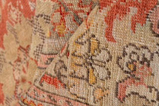 This antique Sivas rug from early 20th-century Turkey exudes timeless elegance with its intricate all-over floral design. Woven in a striking palette of warm coral, ivory, and soft beige, the rug balances  ...