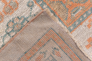 This exceptional antique Oushak rug, woven circa 1900, is a magnificent example of large-scale Anatolian weaving. Measuring over 13 × 16 feet, it features a grand central medallion design flanked by smaller  ...
