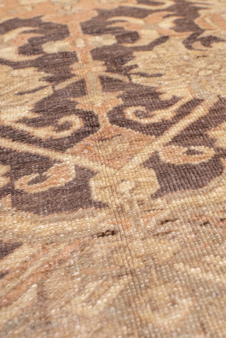 This magnificent antique Oushak rug showcases a highly decorative repeating lattice motif, executed in a refined palette of soft taupe, ivory, muted rose, and charcoal accents. The allover design conveys symmetry and  ...