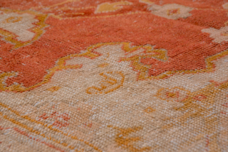 This grand-scale antique Oushak rug from Western Turkey showcases the effortless elegance and luminous color palette for which Oushaks are celebrated. The spacious field features a striking medallion rendered in shades of  ...