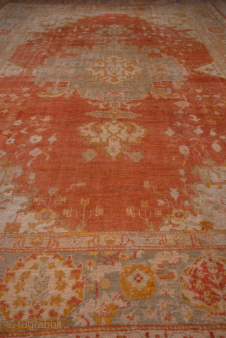 This grand-scale antique Oushak rug from Western Turkey showcases the effortless elegance and luminous color palette for which Oushaks are celebrated. The spacious field features a striking medallion rendered in shades of  ...
